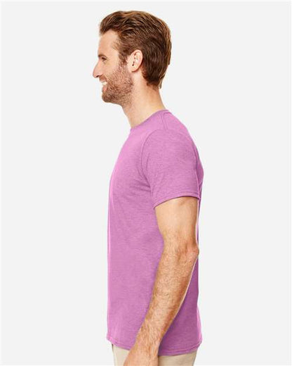 Model wearing a Gildan 64000 Softstyle T-shirt in Heather Radiant Orchid, side view.