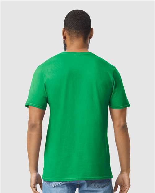 Model wearing a Gildan 64000 Softstyle T-shirt in Irish Green, back view.