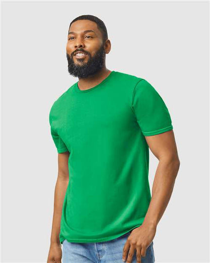 Model wearing a Gildan 64000 Softstyle T-shirt in Irish Green, front view.