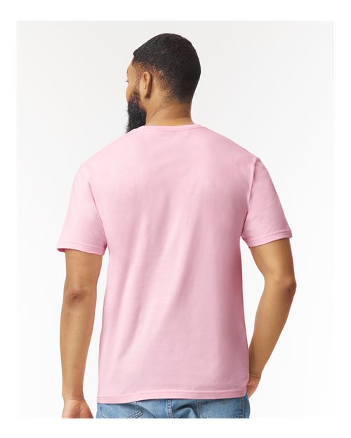 Model wearing a Gildan 64000 Softstyle T-shirt in Light Pink, back view.