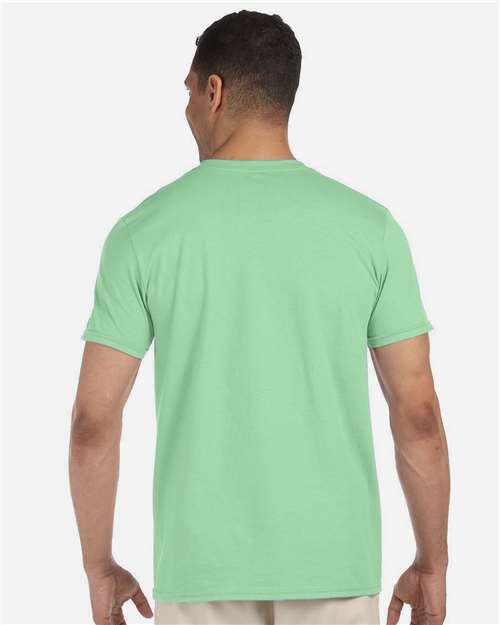Model wearing a Gildan 64000 Softstyle T-shirt in Mint Green, back view.