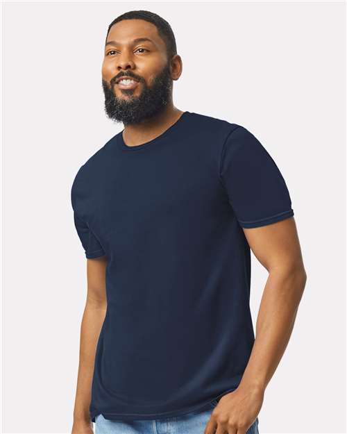 Model wearing a Gildan 64000 Softstyle T-shirt in Navy, front view.