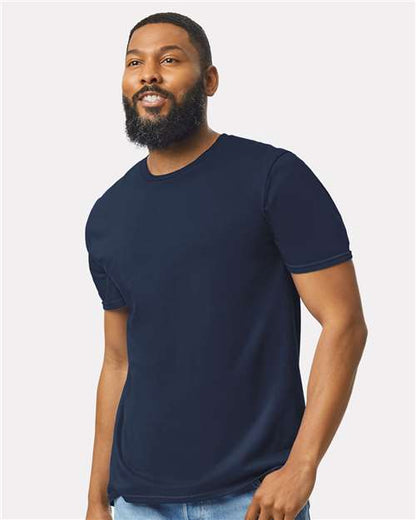 Model wearing a Gildan 64000 Softstyle T-shirt in Navy, front view.