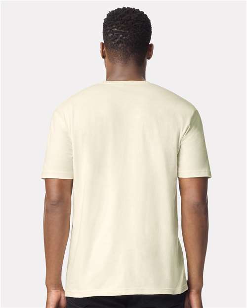 Model wearing a Gildan 64000 Softstyle T-shirt in Off White, back view.