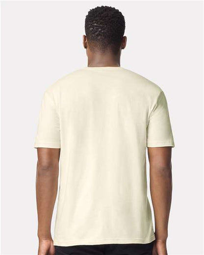 Model wearing a Gildan 64000 Softstyle T-shirt in Off White, back view.