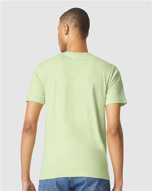 Model wearing a Gildan 64000 Softstyle T-shirt in Pistachio, back view.