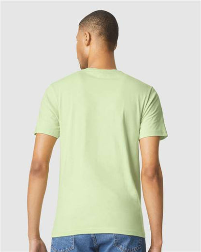 Model wearing a Gildan 64000 Softstyle T-shirt in Pistachio, back view.