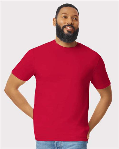 Model wearing a Gildan 64000 Softstyle T-shirt in Red, front view.