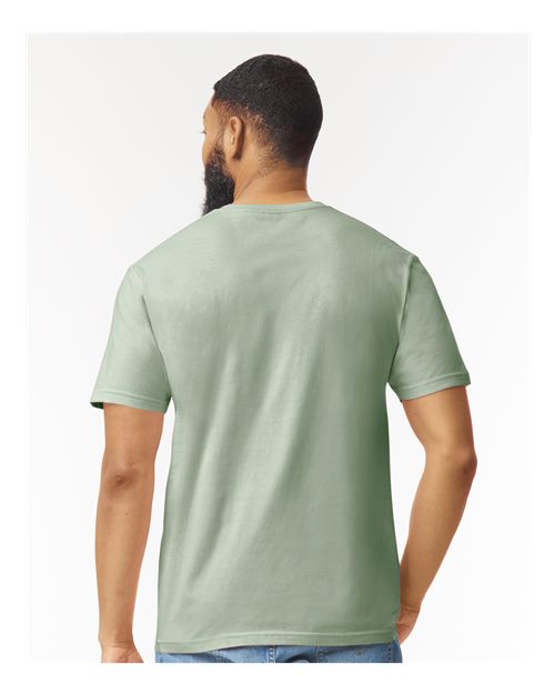 Model wearing a Gildan 64000 Softstyle T-shirt in Sage, back view.