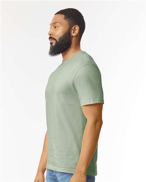 Model wearing a Gildan 64000 Softstyle T-shirt in Sage, side view.