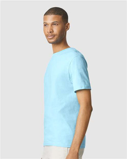Model wearing a Gildan 64000 Softstyle T-shirt in Sky, side view.