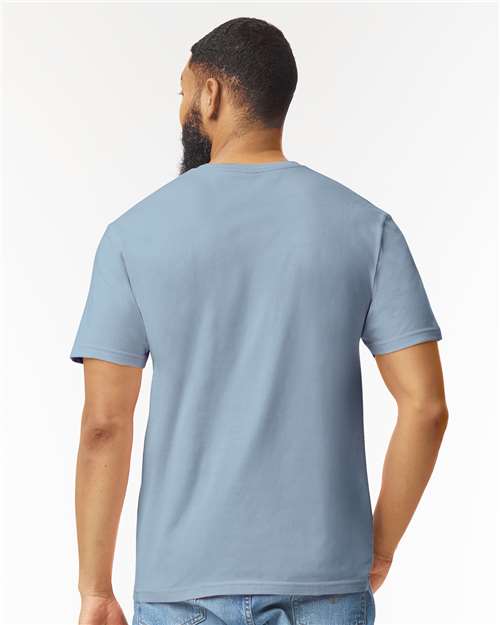 Model wearing a Gildan 64000 Softstyle T-shirt in Stone Blue, back view.