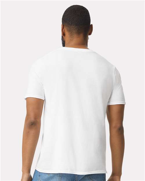 Model wearing a Gildan 64000 Softstyle T-shirt in White, back view.
