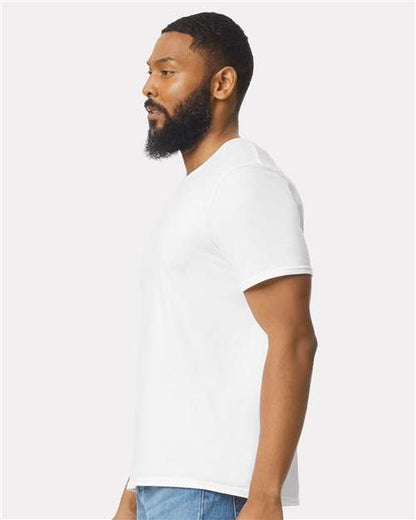Model wearing a Gildan 64000 Softstyle T-shirt in White, side view.