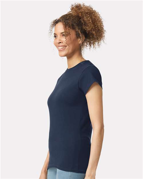Model wearing a Gildan 64000L Softstyle women's T-shirt in Navy, side view.