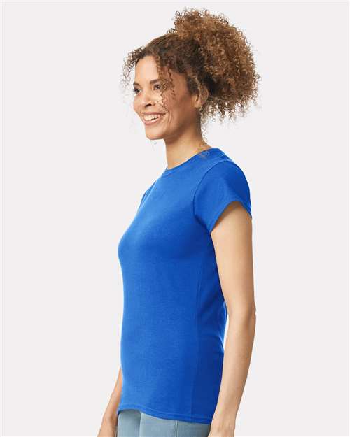 Model wearing a Gildan 64000L Softstyle women's T-shirt in Royal, side view.