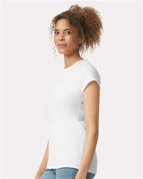 Model wearing a Gildan 64000L Softstyle women's T-shirt in White, side view.