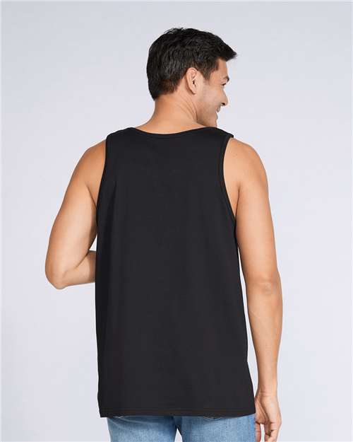 Model wearing a Gildan 64200 Softstyle men's tank top in Black, back view.