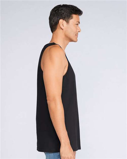Model wearing a Gildan 64200 Softstyle men's tank top in Black, side view.