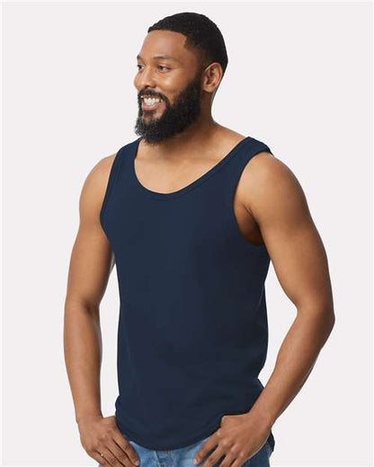 Model wearing a Gildan 64200 Softstyle men's tank top in Navy, side view.