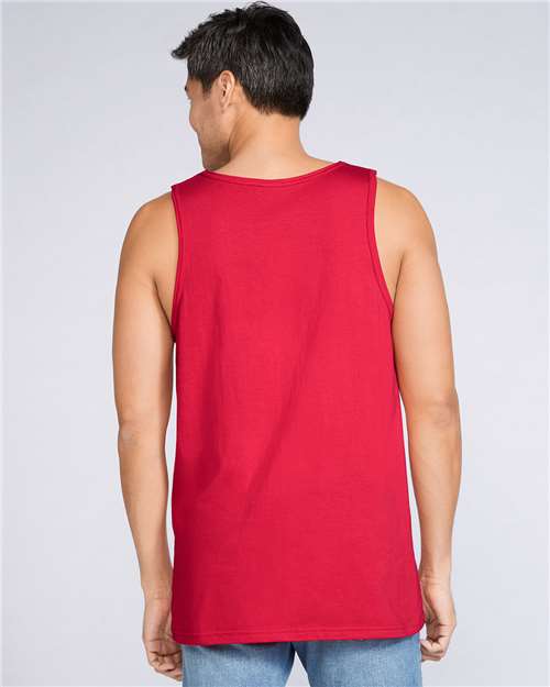 Model wearing a Gildan 64200 Softstyle men's tank top in Red, back view.