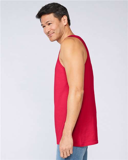 Model wearing a Gildan 64200 Softstyle men's tank top in Red, side view.
