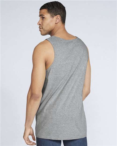 Model wearing a Gildan 64200 Softstyle men's tank top in Sport Grey, back view.