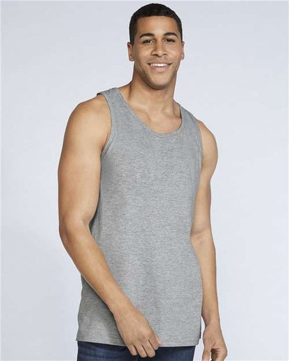 Model wearing a Gildan 64200 Softstyle men's tank top in Sport Grey, front view.