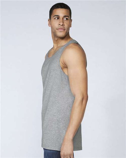 Model wearing a Gildan 64200 Softstyle men's tank top in Sport Grey, side view.