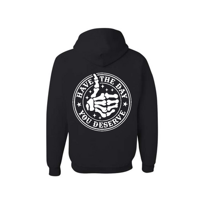 Black Have the Day You Deserve graphic hoodie, back view showing the circular skeleton hand graphic.