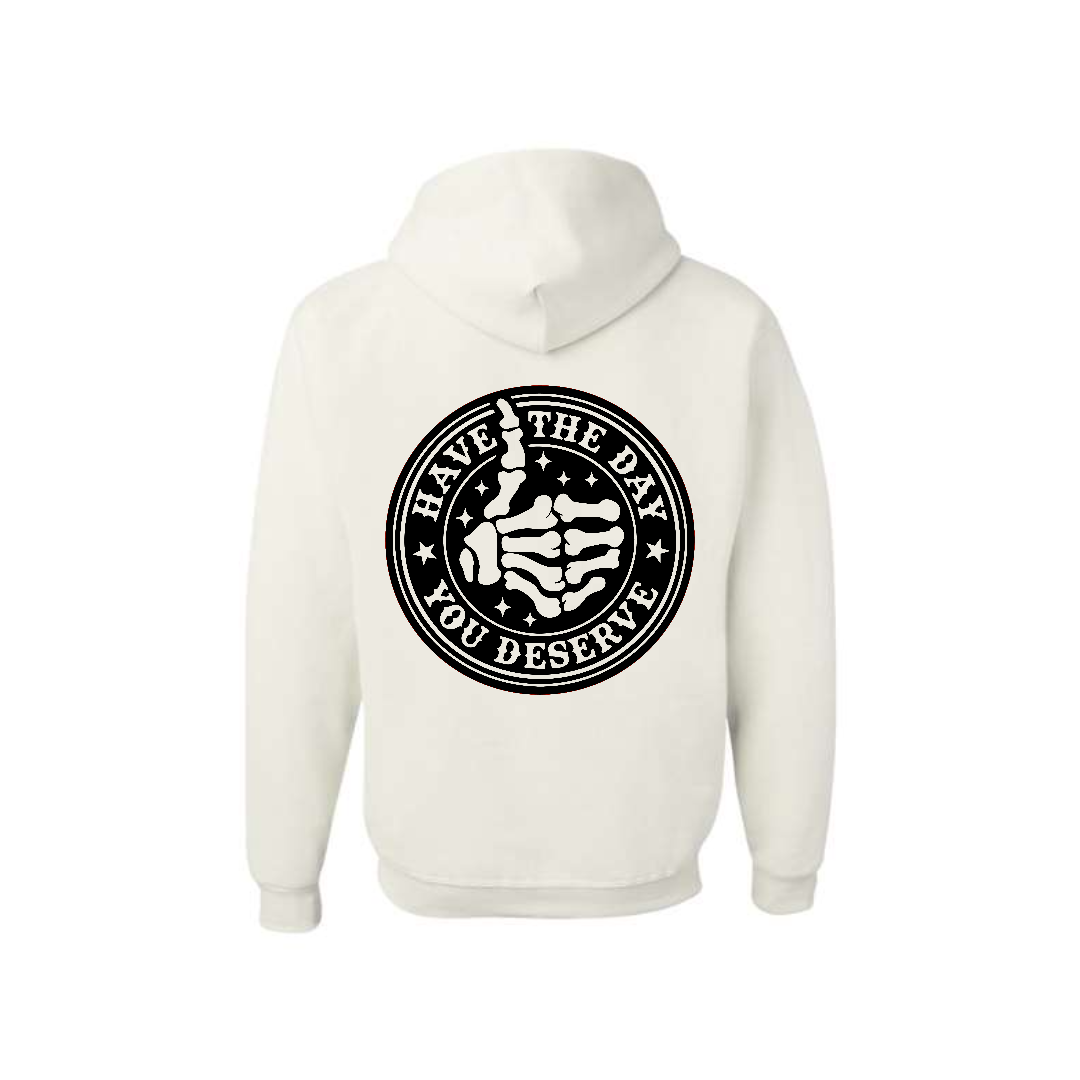 White Have the Day You Deserve graphic hoodie, back view showing the circular skeleton hand graphic.