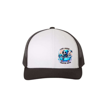Live, Laugh, Toaster Bath 6-panel trucker hat in white with a black brim and black mesh, front product mockup showing a colourful Grim Reaper bathtub patch.