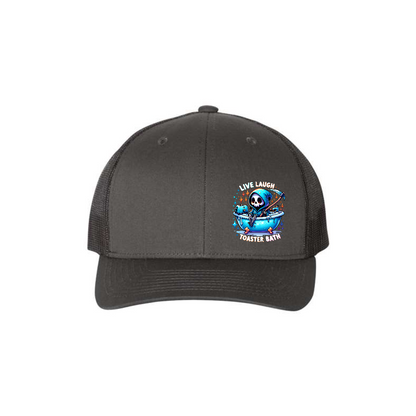Live, Laugh, Toaster Bath 6-panel trucker hat in charcoal with black mesh, front product mockup showing a colourful Grim Reaper bathtub patch.