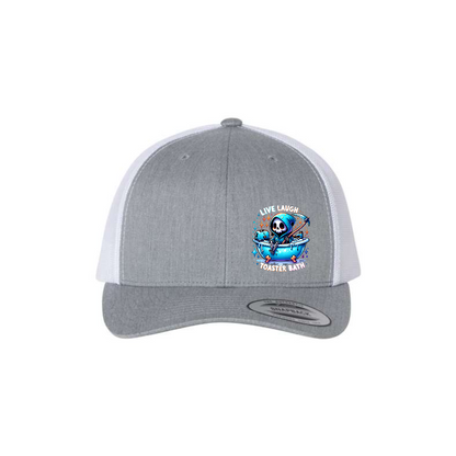Live, Laugh, Toaster Bath 6-panel trucker hat in heather grey with white mesh, front product mockup showing a colourful Grim Reaper bathtub patch.