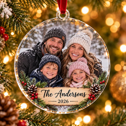 Personalized family photo Christmas ornament featuring a family of four, The Andersons name and 2026 on clear acrylic.