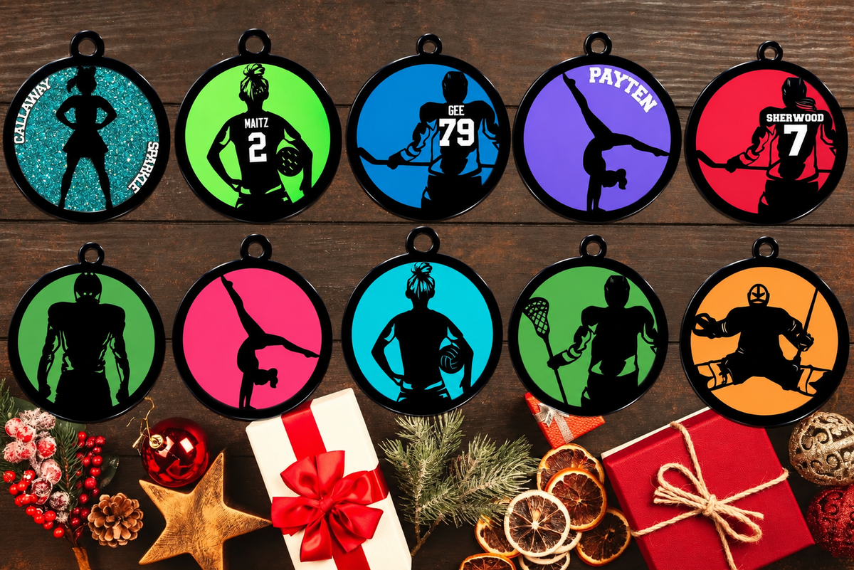 Personalized sports Christmas ornaments with black acrylic silhouettes, coloured bases, names and numbers, including cheerleading, volleyball, hockey and gymnastics.