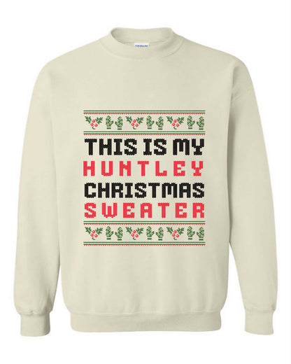 Cream crewneck sweater with This Is My personalized family name Christmas Sweater wording and festive holly and mitten details.