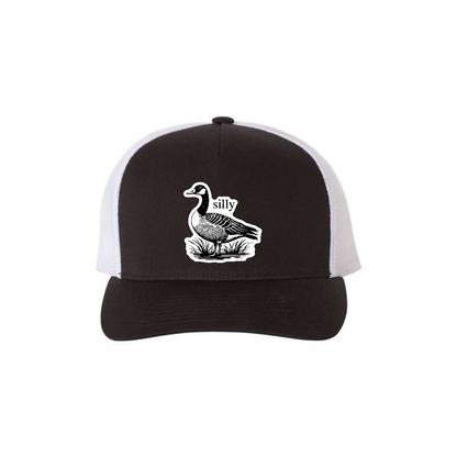 Silly Goose 5-panel trucker hat in black with white mesh, front product mockup showing a white goose design patch.