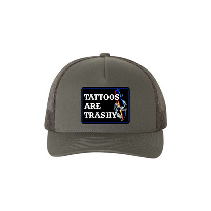 Tattoos Are Trashy Skull Blade 5-panel trucker hat in charcoal, front product mockup showing a black skull and blade design patch.