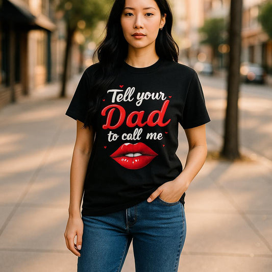 Model wearing a black Tell Your Dad to Call Me graphic T-shirt, front view showing the red and white lettering.