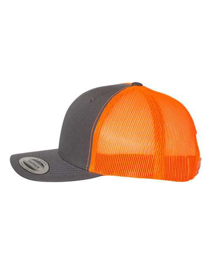 Yupoong 6606 snapback trucker hat in Charcoal/ Neon Orange, angled side view.