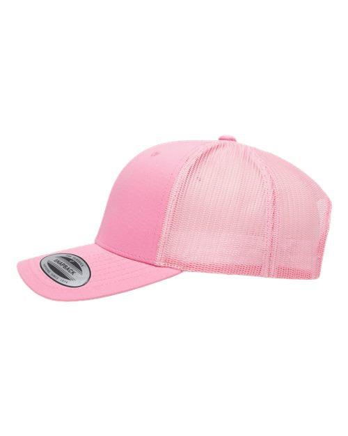Yupoong 6606 snapback trucker hat in Pink, angled side view.
